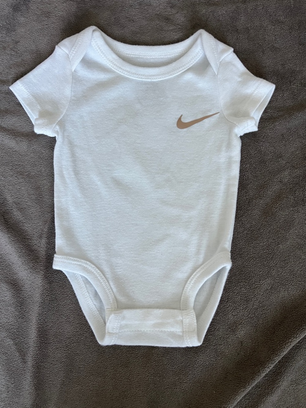 Nike White Baby onesie with Gold Swoosh